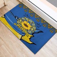 Blue rubber doormat with folk floral border and sunflower peace dove, “Slava Ukraine!”