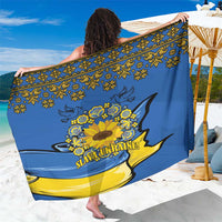 Blue sarong with ornate sunflower peace design and yellow folk motifs, wide spread