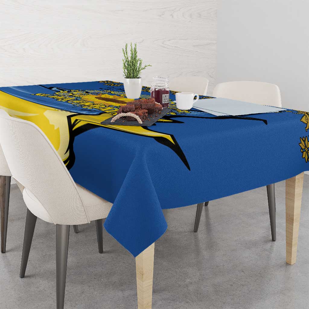 Blue tablecloth on dining table with yellow trident and sunflower folk motif across corner