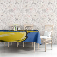 Blue tablecloth on dining table with yellow trident and sunflower pattern