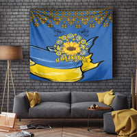 Blue wall tapestry with yellow sunflower wreath, folk border, and "Slava Ukraine!" text