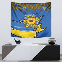 Blue wall tapestry with a central yellow sunflower wreath and "Slava Ukraine!" text