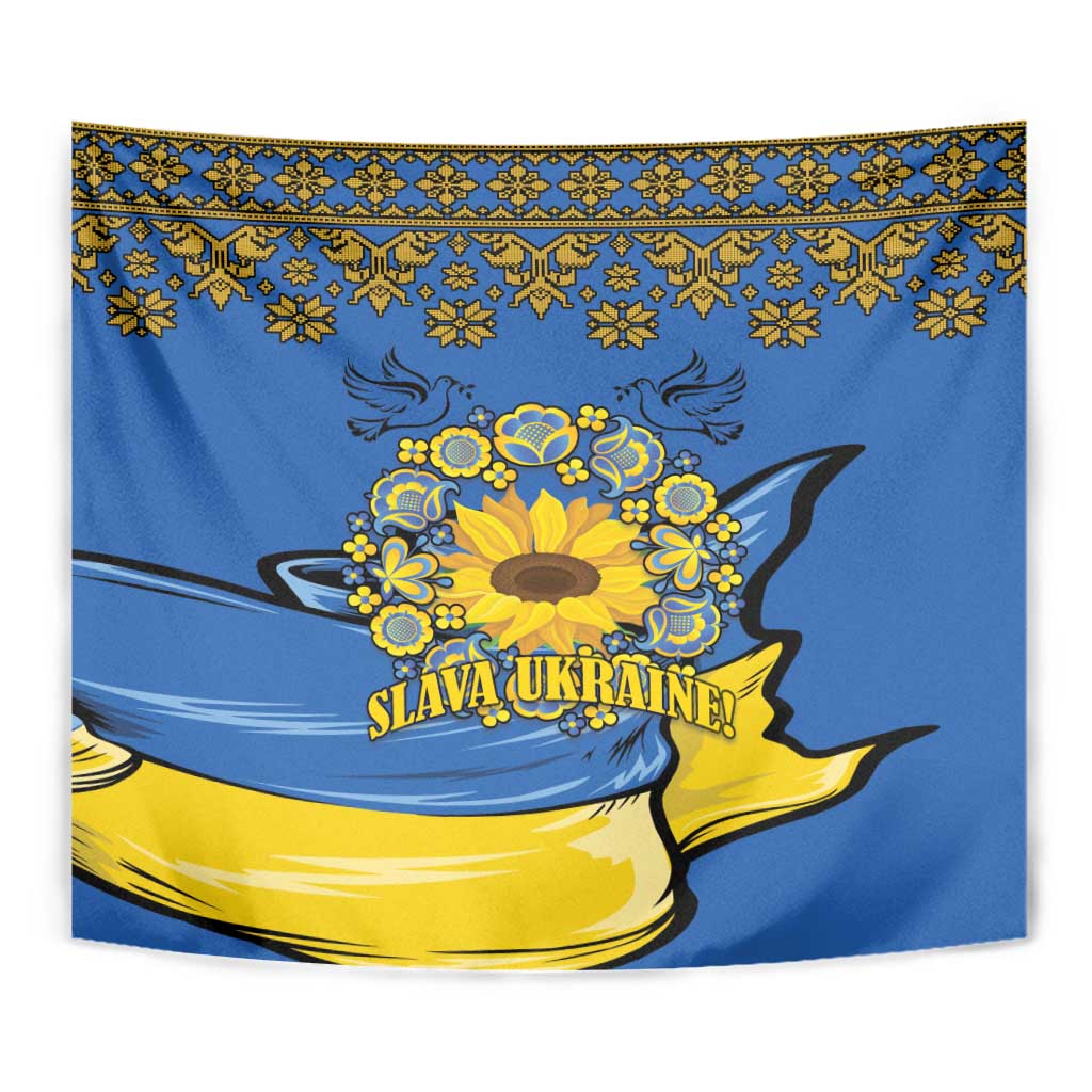 Blue wall tapestry close-up with yellow sunflower wreath, folk top border, "Slava Ukraine!" text