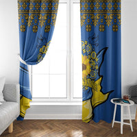 Blue and yellow folk print window curtains hanging on a white-framed door