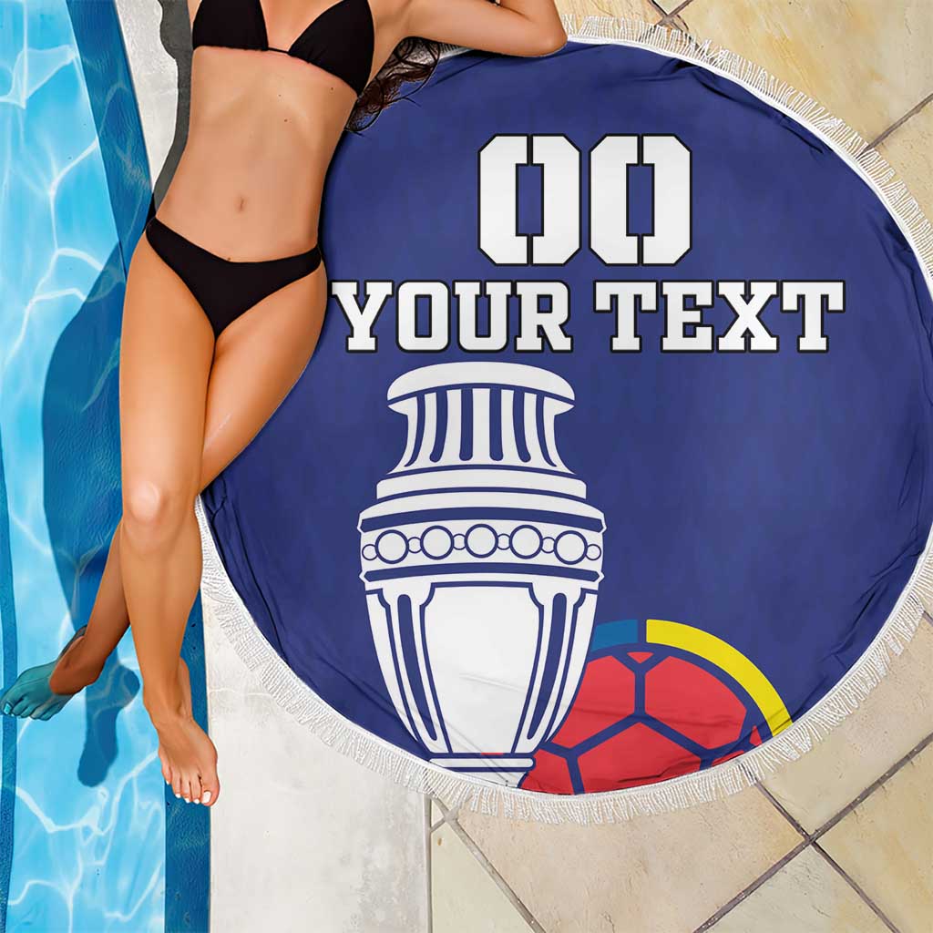 Blue round beach blanket with white fringe edge, 'YOUR TEXT' trophy and partial soccer ball print.