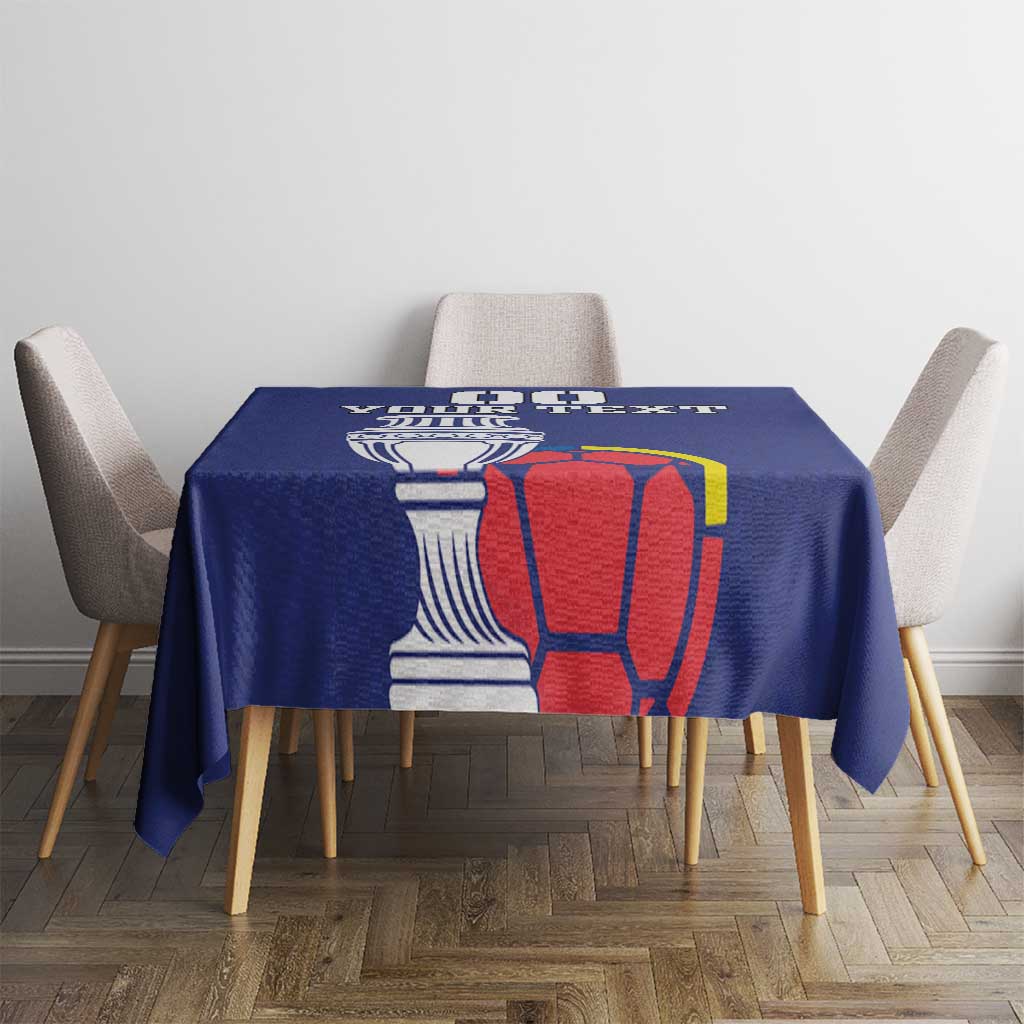 Blue square tablecloth with cup and red football graphic on dining table