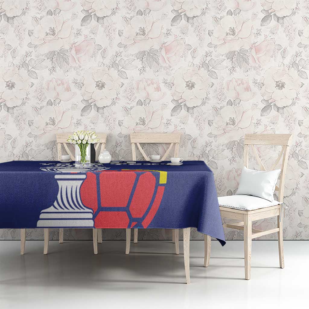 Blue football tablecloth on sofa table with cup and red-yellow football artwork