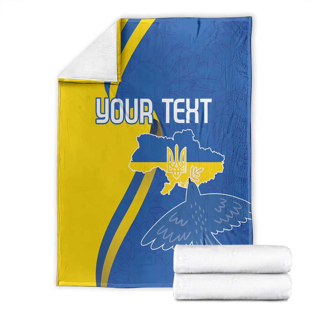 Personalized Ukraine flag blanket with peace dove and YOUR TEXT, folded with stacked white rolls