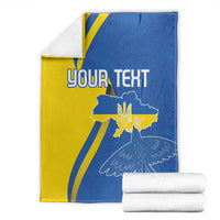 Personalized Ukraine flag blanket with peace dove and YOUR TEXT, folded with stacked white rolls
