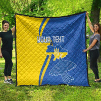 Blue and yellow quilt spread outdoors, diagonal stripe design with peace dove and “YOUR TEXT”