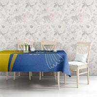 Blue tablecloth with yellow stripe and peace dove print across table seating