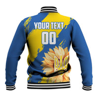 Blue baseball jacket with yellow back graphic, ribbed collar, button front, striped cuffs