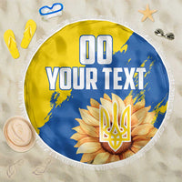 Round beach blanket with fringed edge, yellow-and-blue sunflower trident graphic