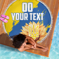 Round beach blanket with fringed edge, yellow/blue sunflower trident emblem graphic