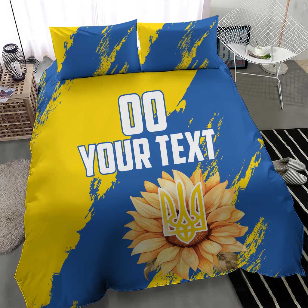 Blue and yellow duvet cover set with two pillows, central 'YOUR TEXT' and flower emblem
