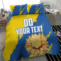 Blue and yellow duvet cover set with two pillows, central 'YOUR TEXT' and flower emblem