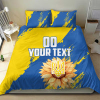 Blue and yellow duvet cover set with two pillows, 'YOUR TEXT' and flower emblem centerpiece