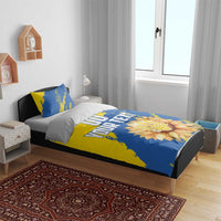 Blue and yellow duvet cover set with two pillows, visible 'YOUR TEXT' and flower emblem