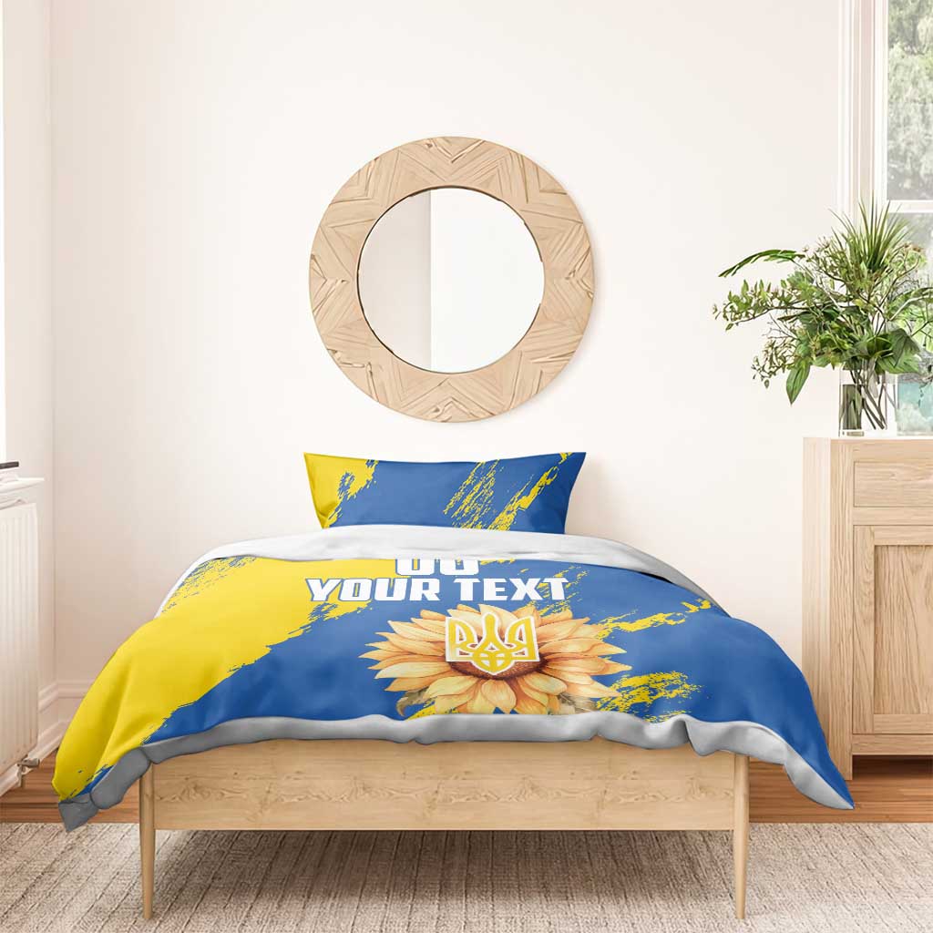 Blue and yellow duvet cover set with two pillows, 'YOUR TEXT' banner and flower emblem