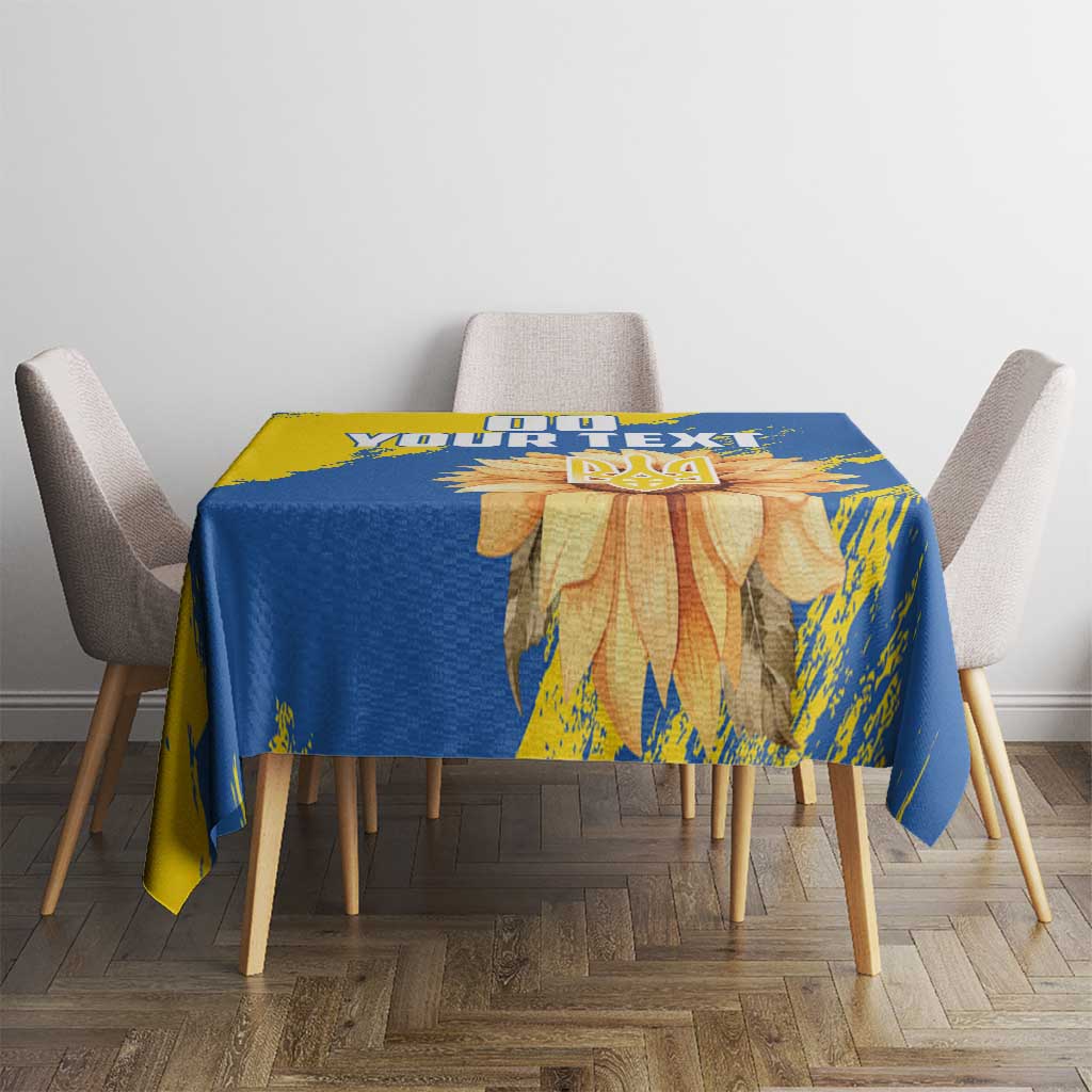 Blue and yellow tablecloth with sunflower and trident design on tabletop