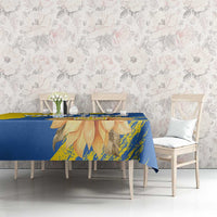 Blue and yellow tablecloth with sunflower and trident print on rectangular table