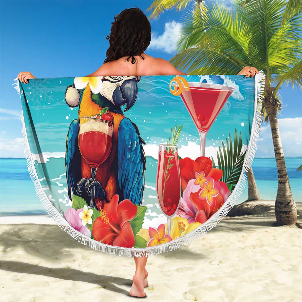 Round blue beach blanket with fringe, parrot and 'Merry Christmas' on sandy beach