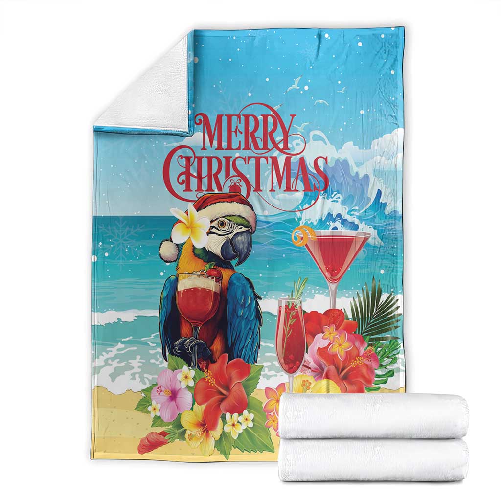 Blue tropical Christmas blanket and folded towels, parrot, flowers, and martini drinks