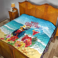 Blue Christmas quilt on a bed with tropical parrot, rum punch cocktail, and “Merry Christmas”