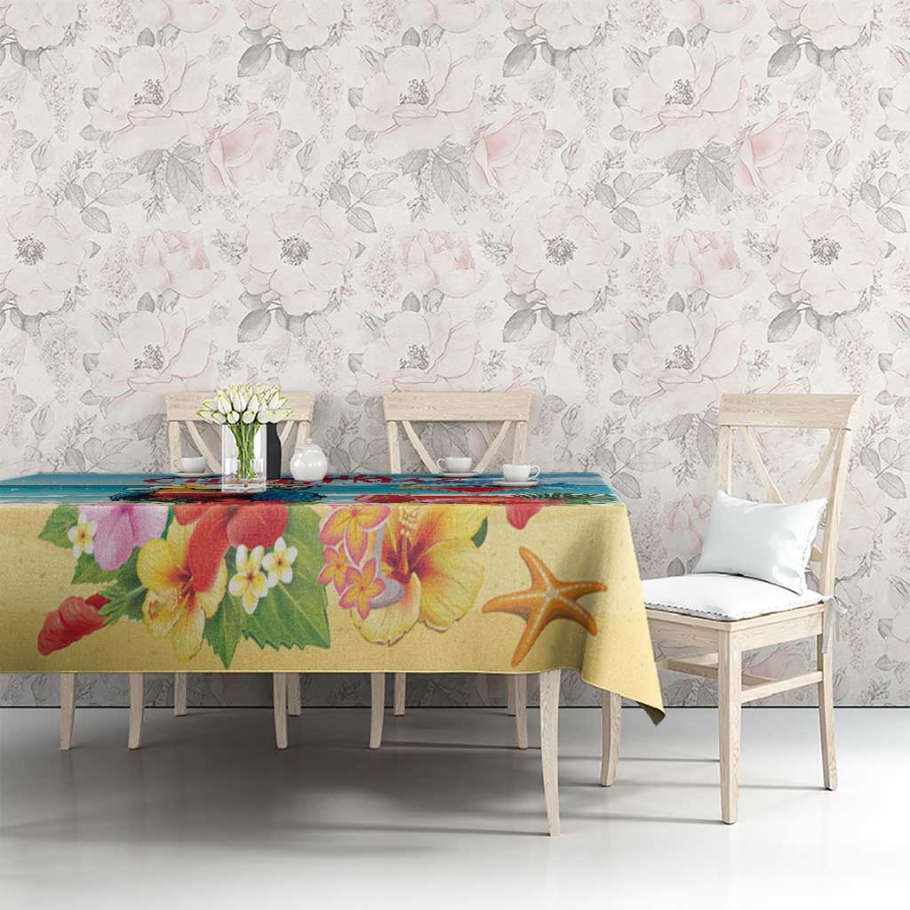 Yellow tropical Christmas tablecloth with floral print and starfish on dining table
