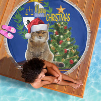 Blue round Christmas beach blanket with white fringe, cat with Santa hat and Christmas text