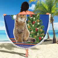 Blue round Christmas beach blanket with white fringe, cat in Santa hat, decorated tree