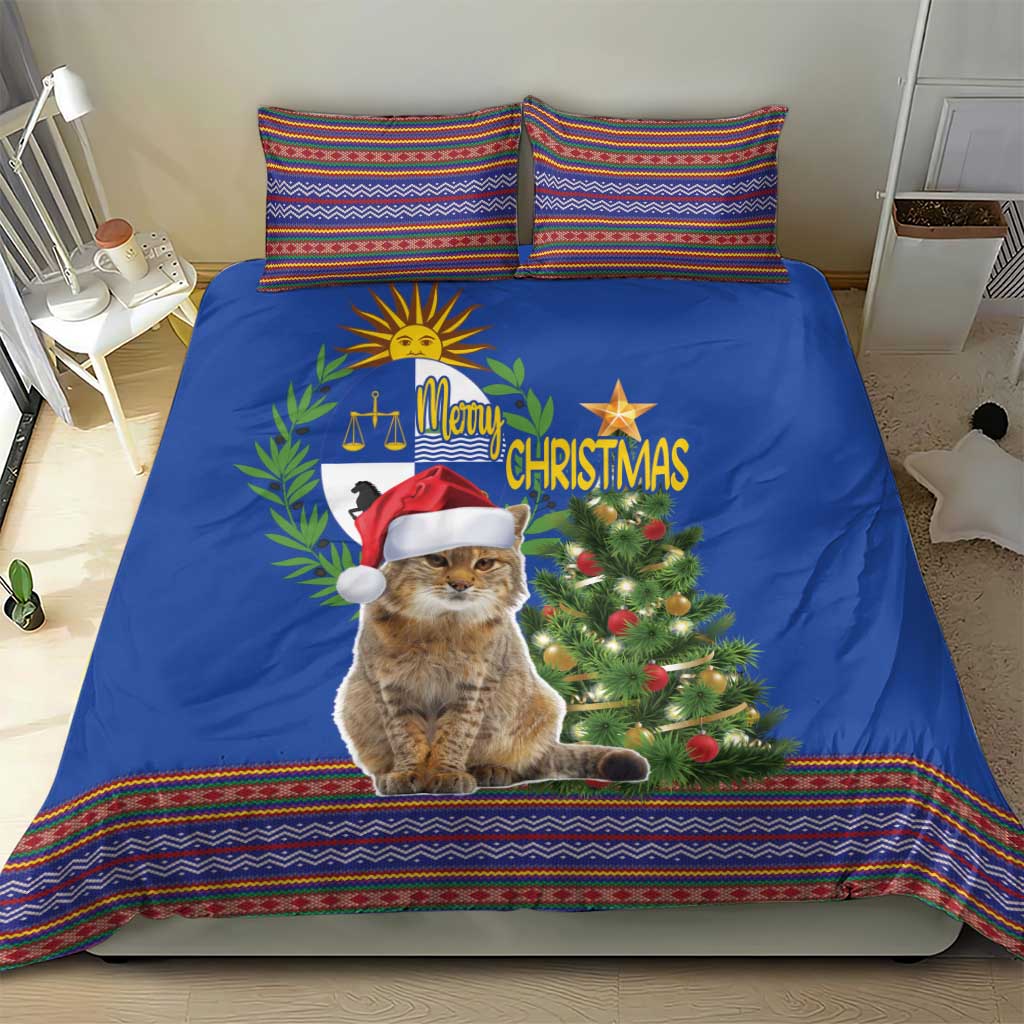 Blue Christmas bedding set on bed with cat in Santa hat, Christmas tree and folk trim
