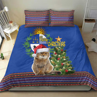 Blue Christmas bedding set on bed with cat in Santa hat, Christmas tree and folk trim