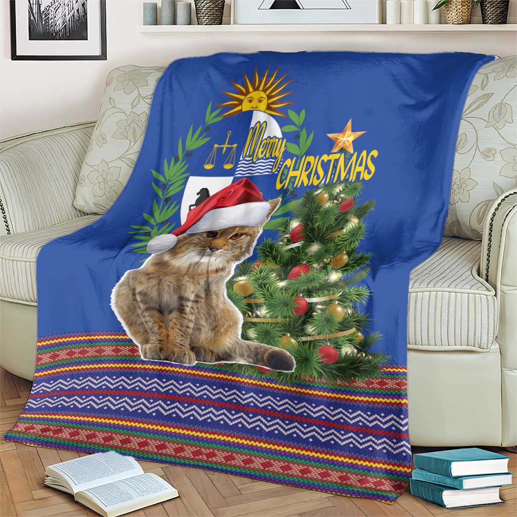 Blue Christmas blanket with cat wearing red Santa hat, evergreen tree, and folk border stripes