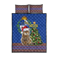 Blue Christmas quilt bed set showing cat, tree graphic, and two striped pillowcases