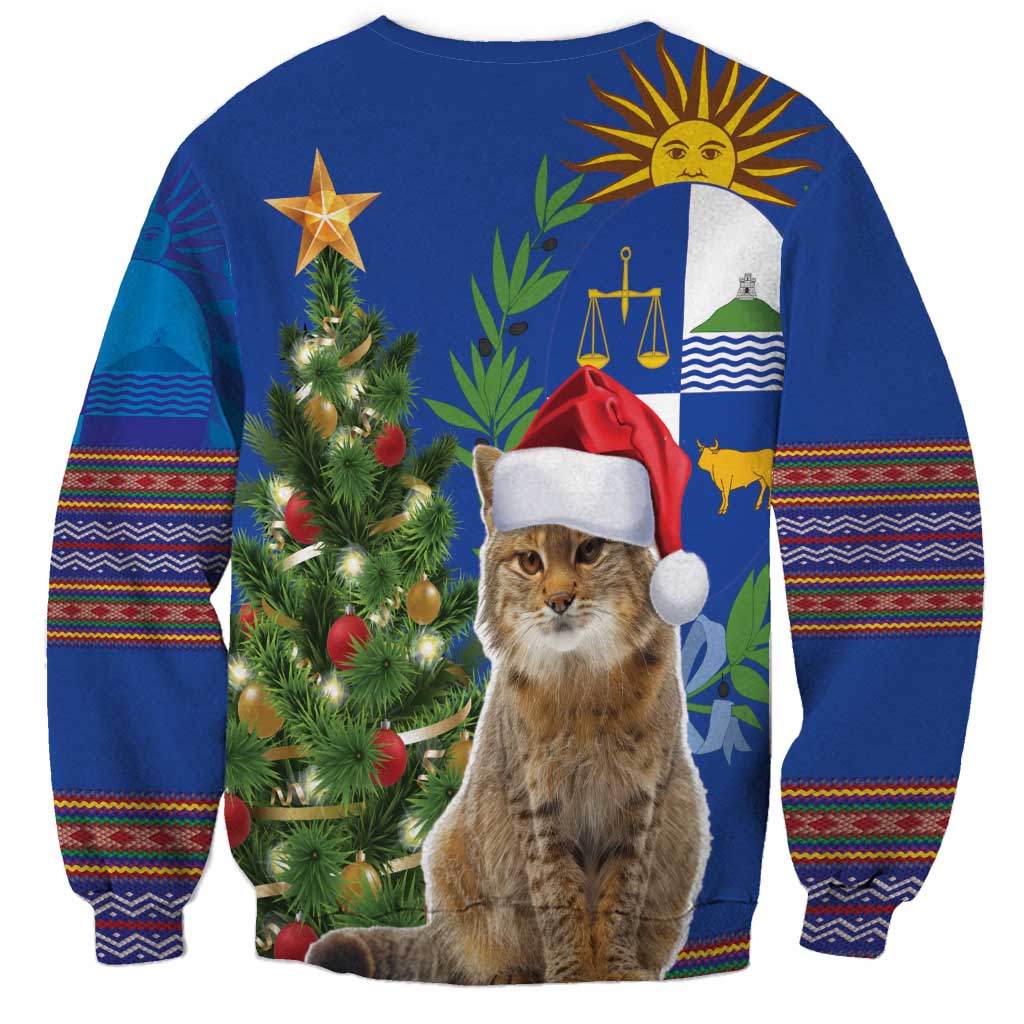 Blue unisex Christmas sweatshirt with cat in Santa hat, tree lights, and folk patterned sleeves