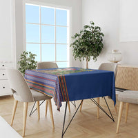 Blue Christmas tablecloth with multicolor zigzag and striped folk pattern, draped on table