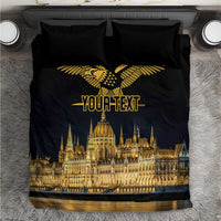 Black bedding set with gold bird emblem and Budapest-style skyline graphic, plus matching pillows