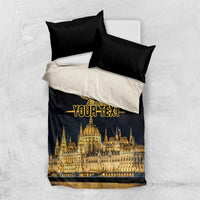 Black and white bedding set with gold bird emblem and skyline print, two black pillowcases