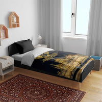 Black duvet cover with gold bird emblem and skyline print on a wooden bed with pillows