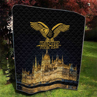 Black quilt with gold eagle and Budapest Parliament skyline, shown folded on grass