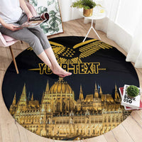 Black round carpet showing gold skyline, Turul bird design, and “YOUR TEXT” centered