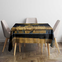 Black tablecloth centered on dining table with golden Budapest landmark and gold band design