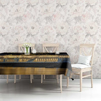 Black tablecloth on table with golden Budapest landmark graphic beneath floral wall decor