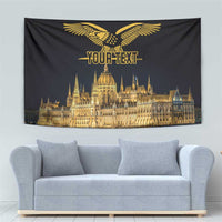 Black tapestry showing gold turul bird, 'YOUR TEXT', and illuminated Budapest skyline