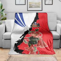Chile flag blanket on gray couch, red white black design with star and rose detail