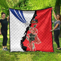 Chile flag quilt spread on grass, white/blue half and red half with floral artwork