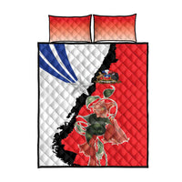 Red quilt and two pillowcases with Chile flag-style split design and central floral artwork