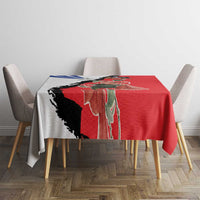 Red tablecloth with Chile-themed print over table, visible black and blue accents