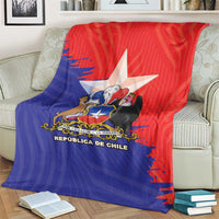 Chile flag-style blanket with large central coat of arms, red and blue on couch
